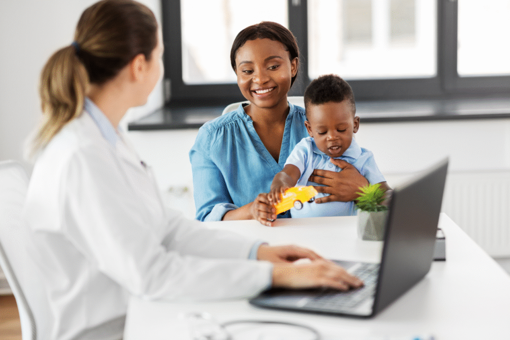 A pediatrician with a mother and her toddler son.